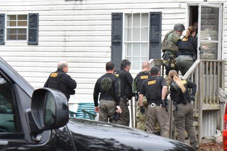 Officers entering house