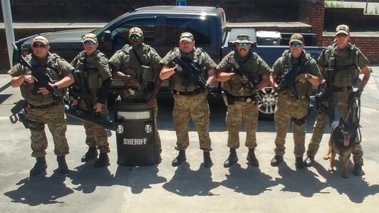 SWAT Officers with weapons and shield